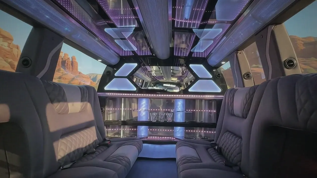Inside the Cadillac Escalade limo in Golden: LED light-show ceiling, leather lounge seating and lit bar